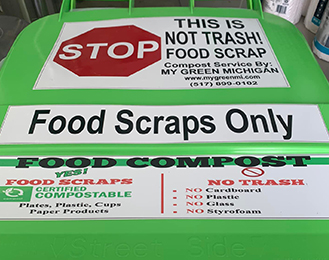Large food compost bin that had signage reading food scraps only and this is not trash.