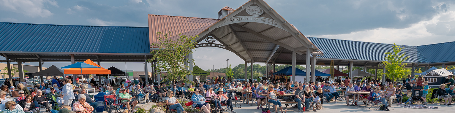 Photo of the Marketplace on the Green Pavilion with people looking towards the stage
